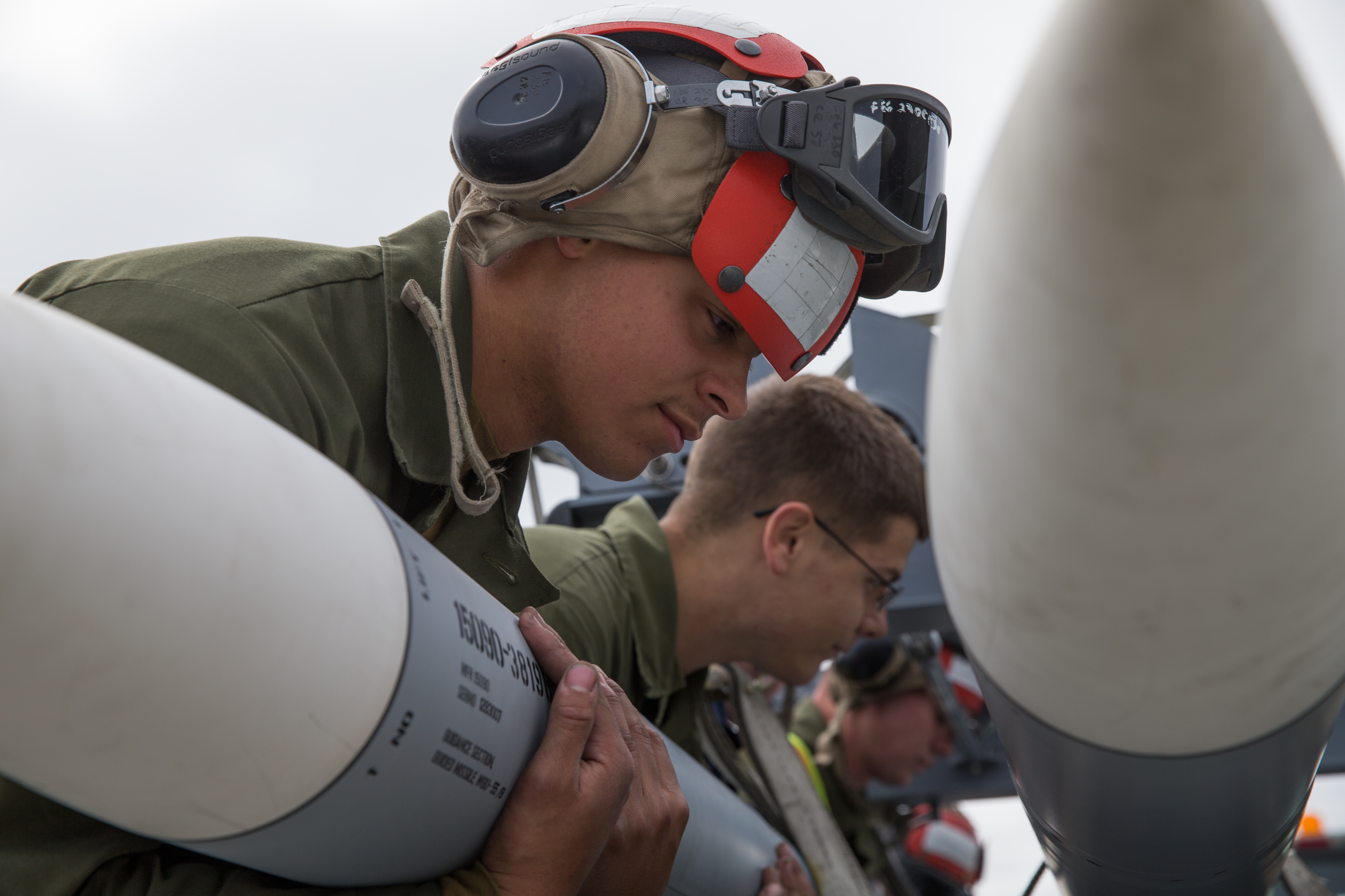 U.S. Marines assigned to Marine Fighter Attack Squadron 251 carry ordnance to an F/A-18C Hornet during Red Flag-Alaska 17-2 on Joint Base Elmendorf-Richardson, Alaska, June 20, 2017. Red Flag Alaska provides an optimal training environment in the Indo-Asian Pacific region and focuses on improving ground, space, and cyberspace combat readiness and interoperability for U.S. and international forces. (U.S. Marine Corps photo by Lance Cpl. Koby I. Saunders)